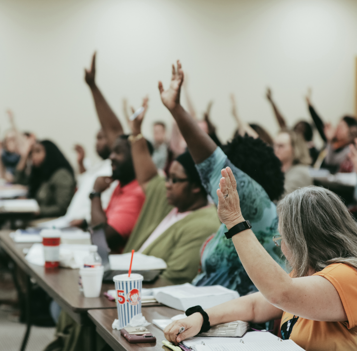 adults raising hands