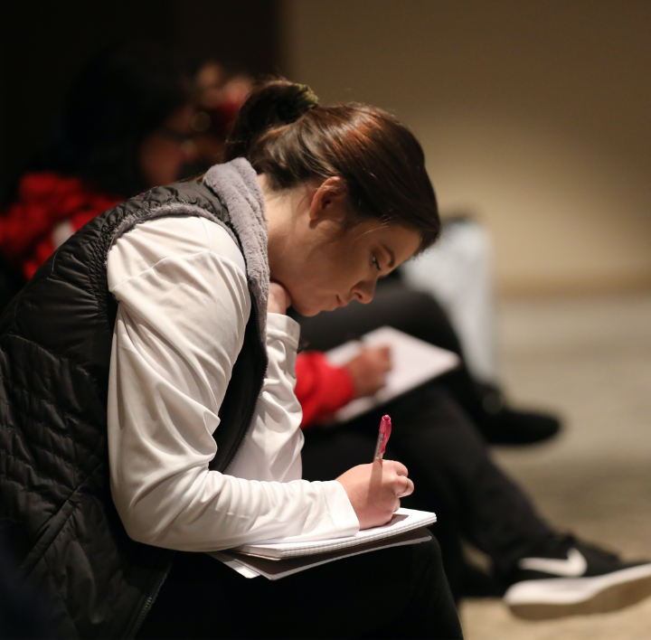 young adult taking notes