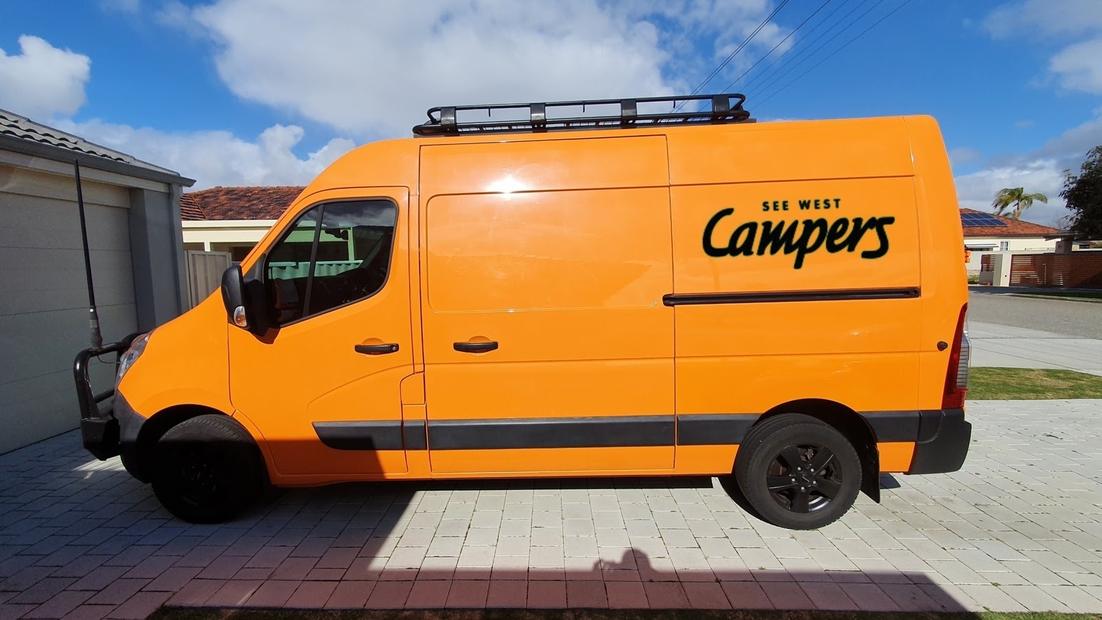 orange motorhome parked in driveway