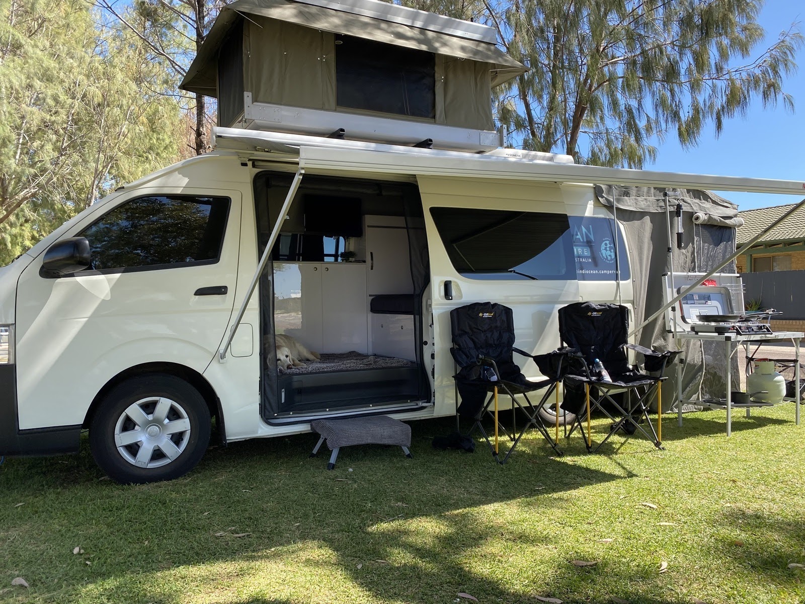 Motorhome parked on grass opened up