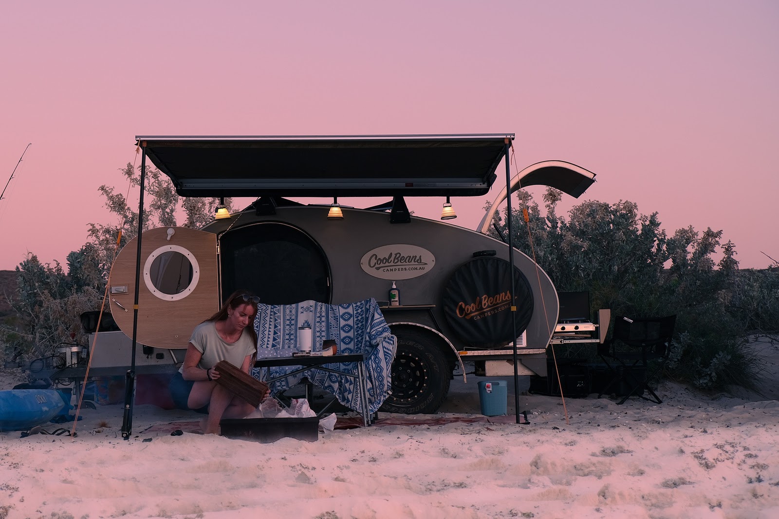 campervan parked on beach at sunset