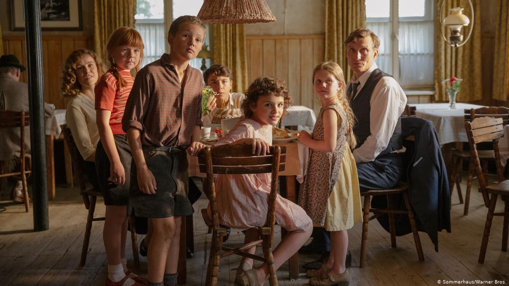 still from movie, family with five children around dinner table