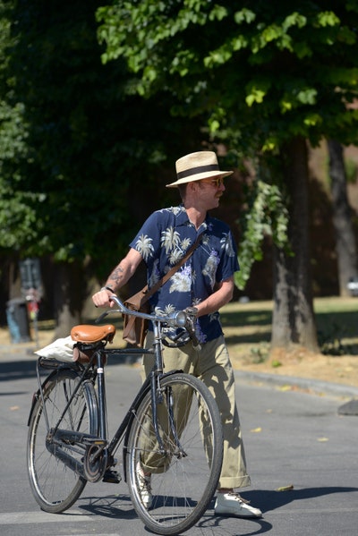 Image may contain Wheel Machine Transportation Vehicle Bicycle Bike Human Person Hat Clothing and Apparel