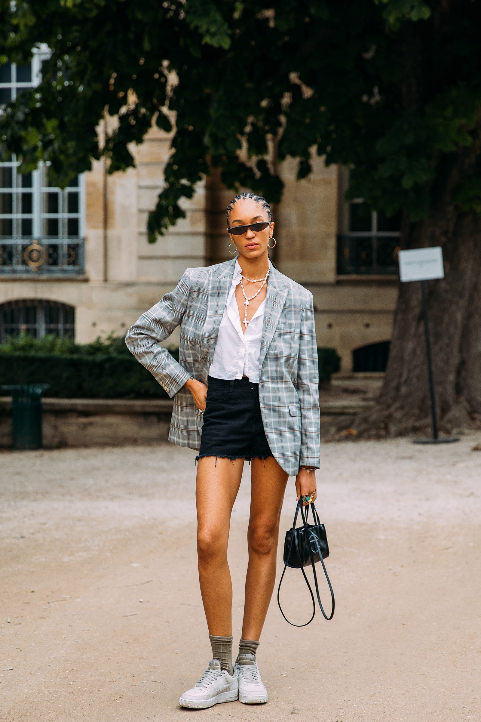 Image may contain Shorts Clothing Apparel Human Person Sunglasses Accessories Accessory Footwear Shoe and Shirt