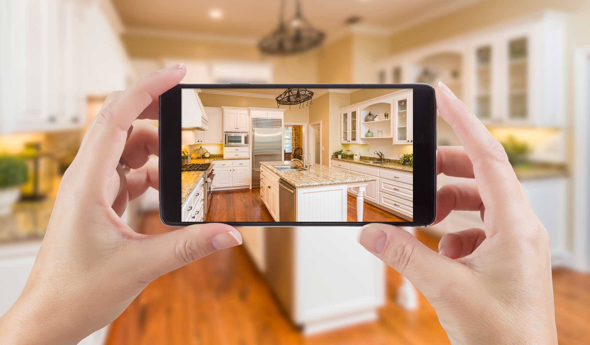 Someone taking a video of their kitchen via their mobile phone