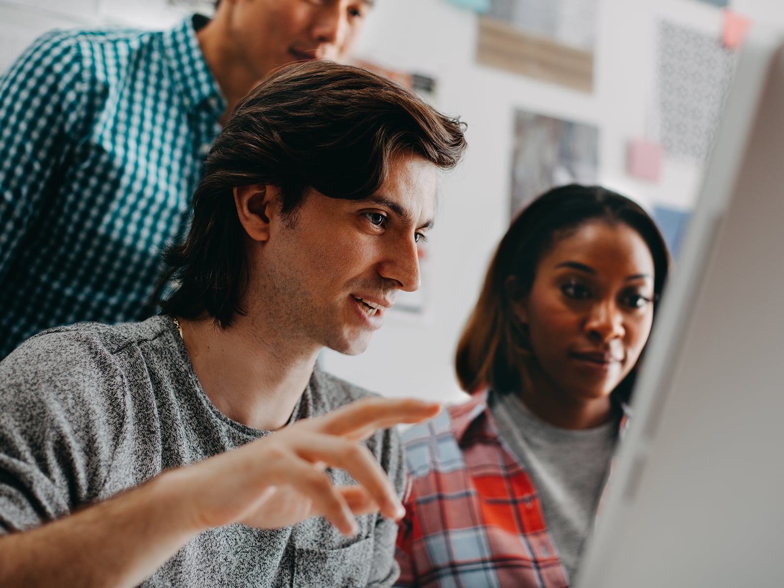 Man and woman collaborating in front of a computer