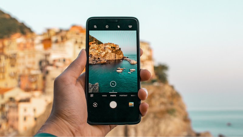 A mobile device with an ocean landscape in the background