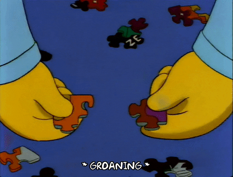 simpson character trying to fit two puzzle pieces together that won't fit