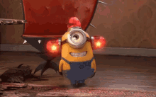 A yellow minion from the film Despicable Me is seen wearing a cap made of red flashing lights.