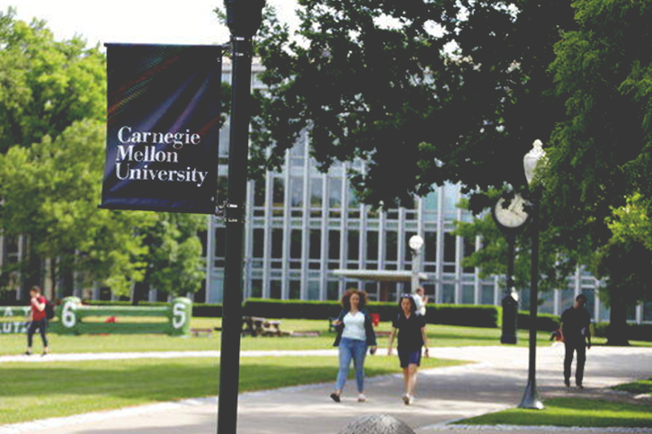 An image of the campus quad of Carnegie Mellon University with students walking to class