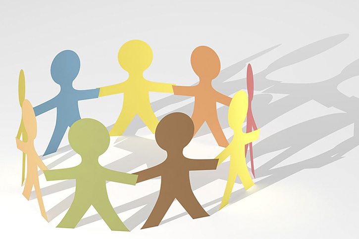 A stylized image of paper cut-out people of many colors joining hands in a circle