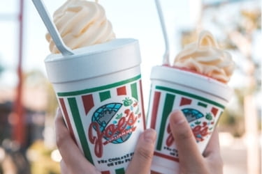 Hands holding two cups of Joe's Italian Ice cream