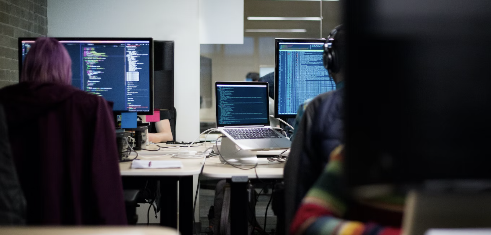 Image of tech workers working on their devices