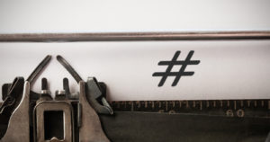Hashtag symbol against close-up of typewriter