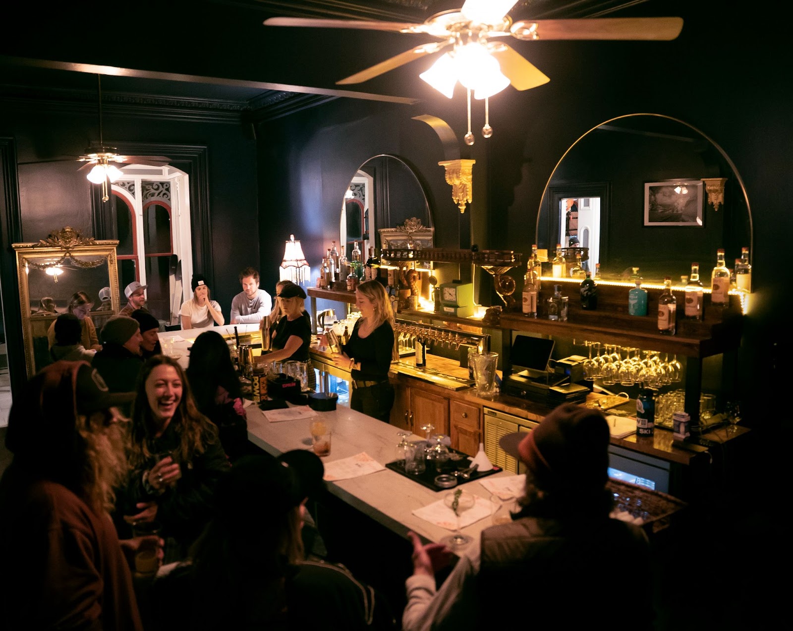A crowd of people sitting at the bar inside RMU Truckee.