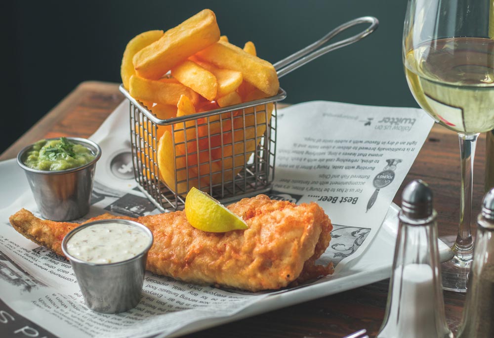 Food Photography - fish and chips show on newspaper wrapping paper.