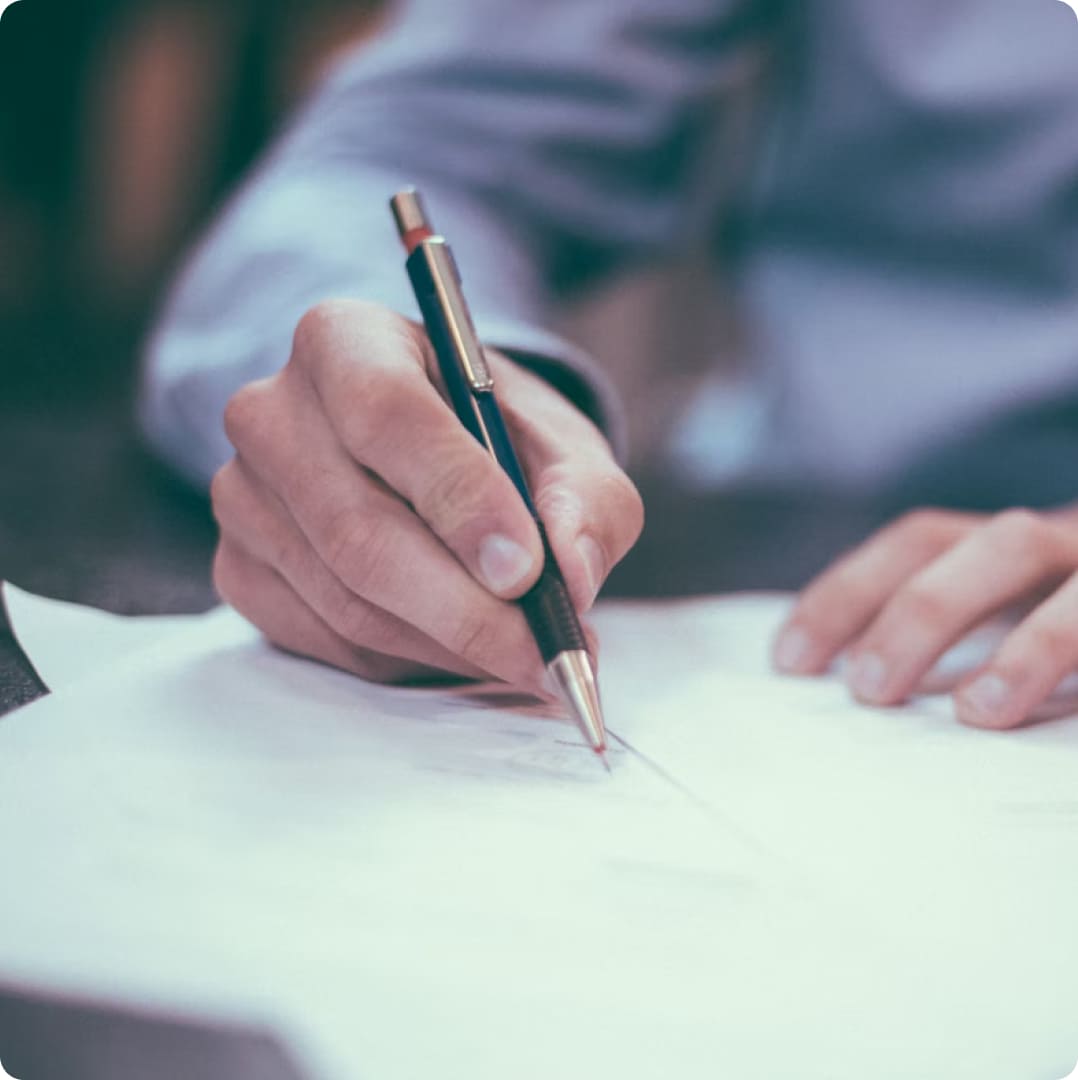 photo of a man holding a pen