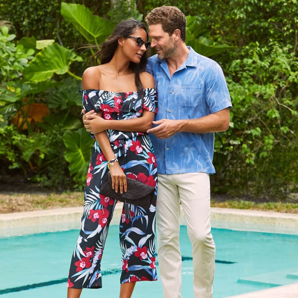 Young couple wearing Tommy Bahama apparel next to a pool