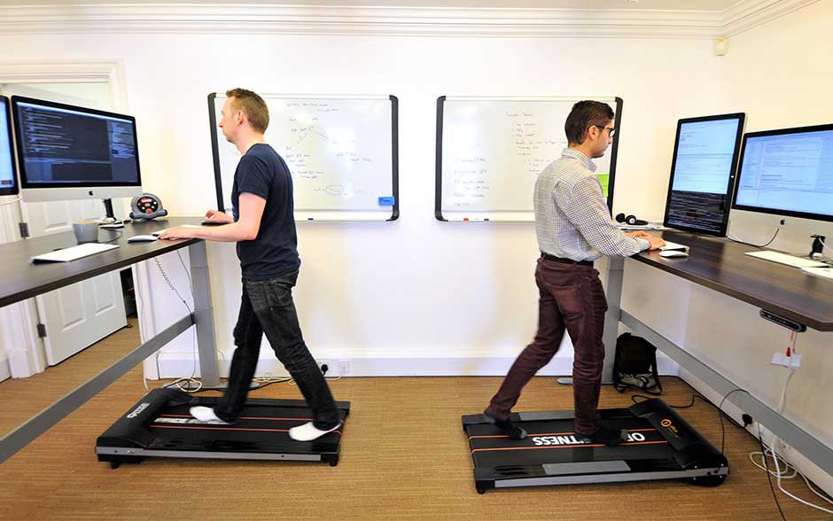DEvelopers on standing desks with treadmill