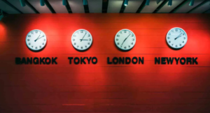 Clocks with times from around the world on a red wall - Bangkok, Tokyo, London, New York
