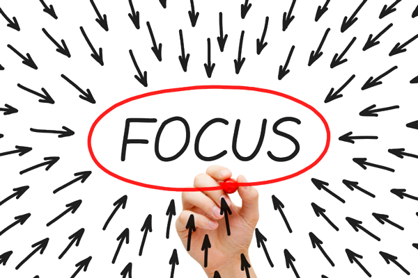 Hand with red marker circling "Focus" with many arrows pointing inward