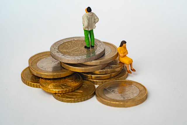 Divorced figures standing on money