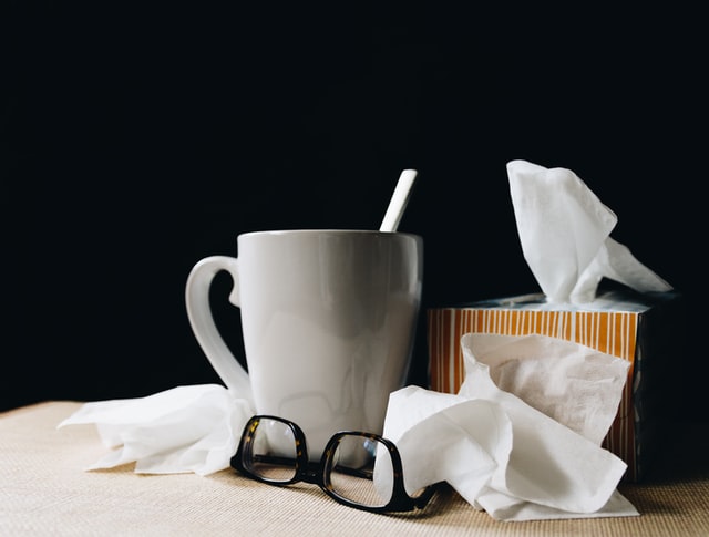 Used tissues, mug and glasses.