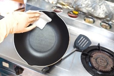 Hands cleaning a pot