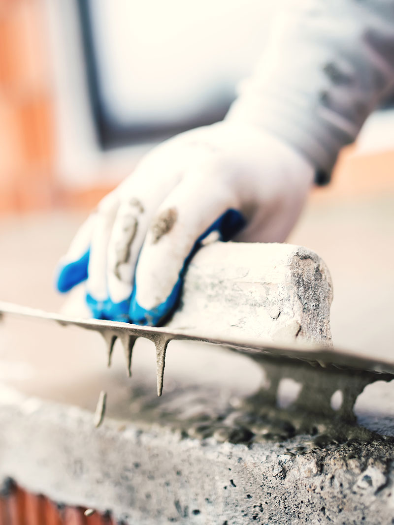A worker finishing concrete