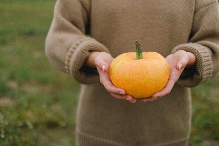 woman holding a squash farm to table eating