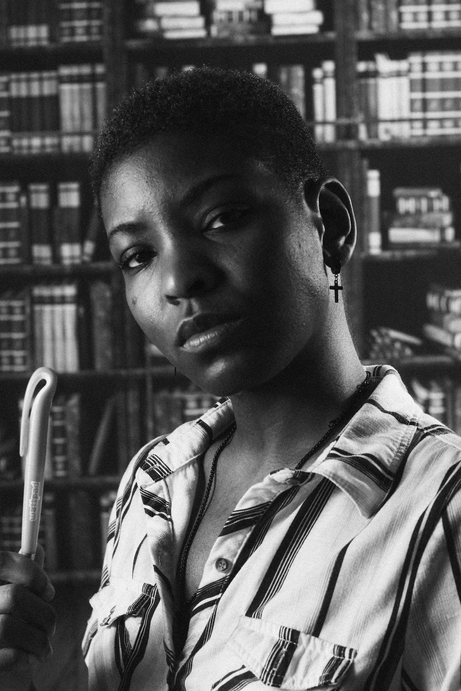 Portrait of a black female model inside a library.