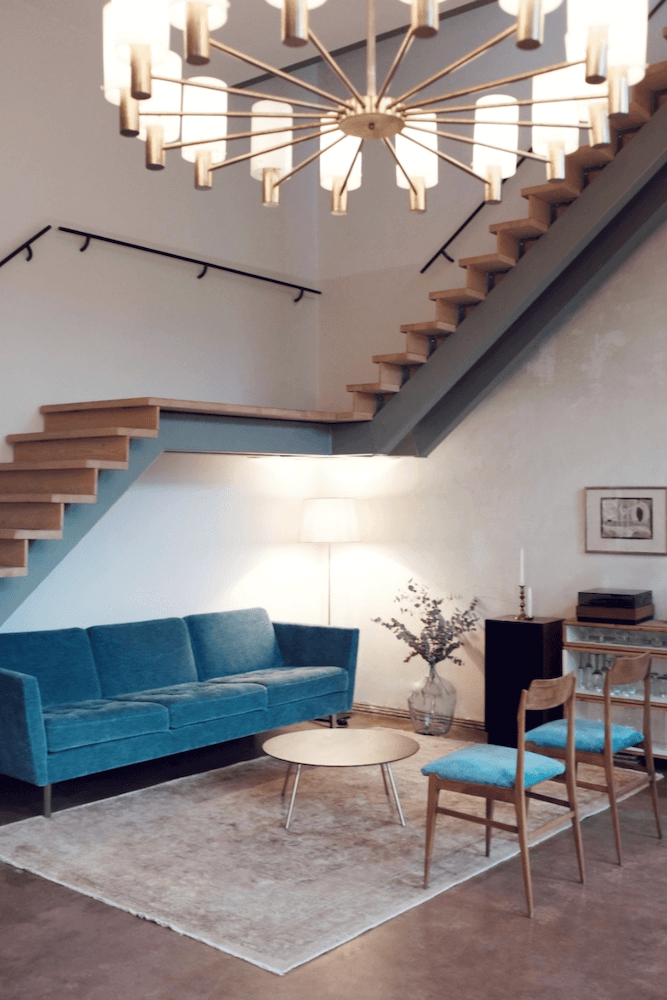 Artist loft with huge staircase available for rent for your next film production in Berlin, Germany. Minimalist and unique interior design