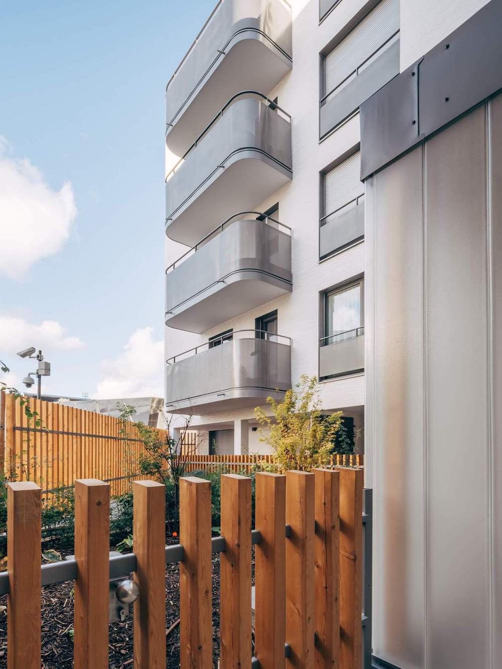 Interior garden in a building with metal balconies.