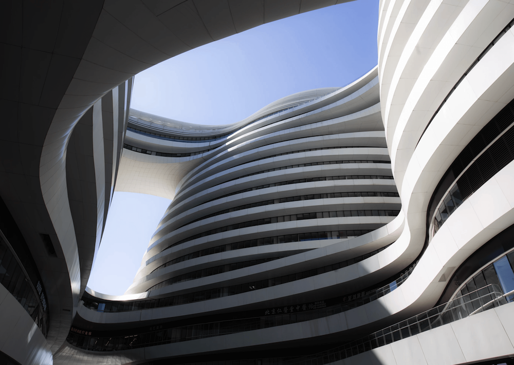 Symmetrical, curved facade of a modernist building.