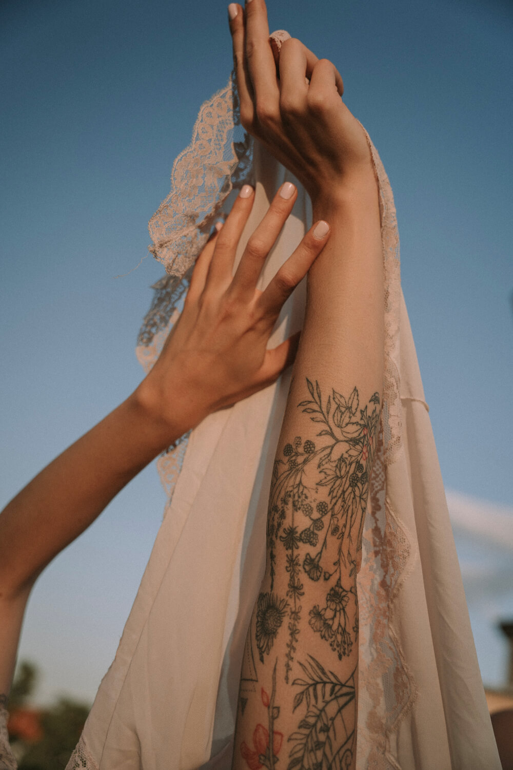 Hands with tattoos and embroided fabric in Berlin by photographer Krystsina Shyla