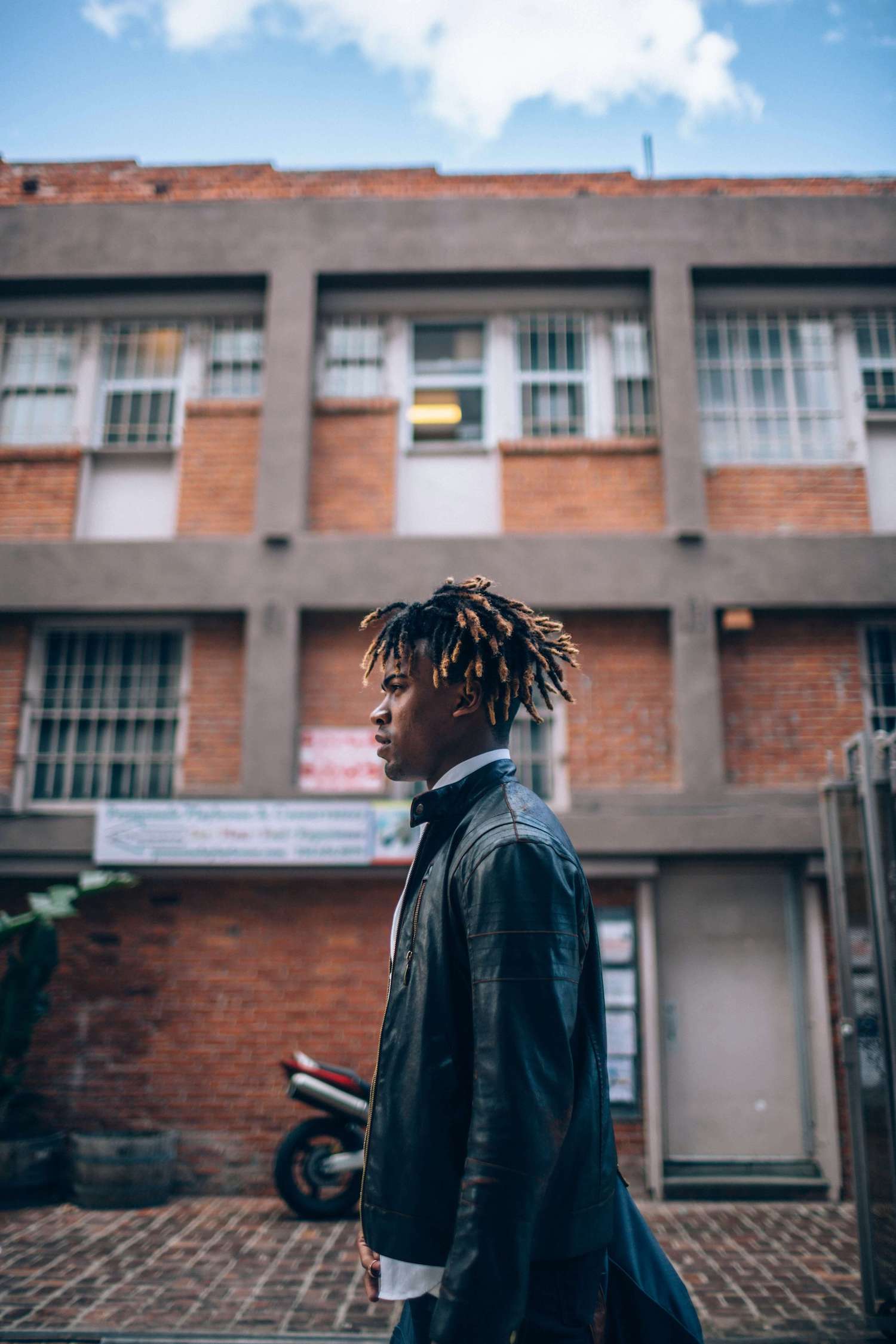 Male model walking in an industrial street.