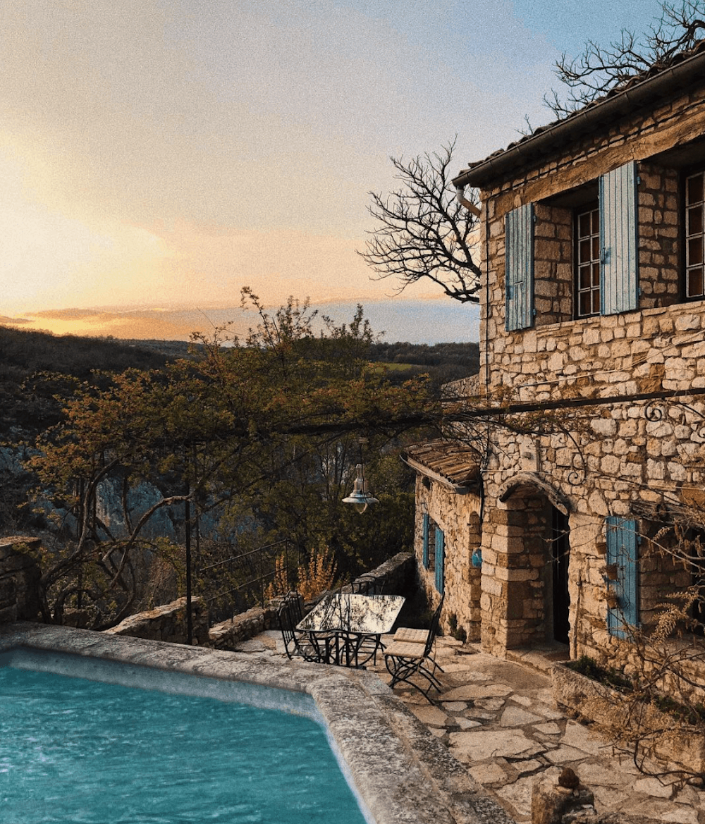 A rural house with swimming pool, during the sunset.
