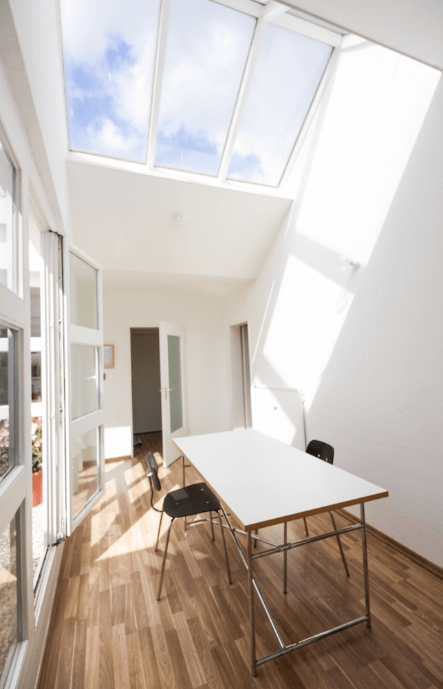 Dining room of a rooftop garden apartment in architect building, available to rent as a film location in Berlin, Germany. Extremely bright for photoshoots