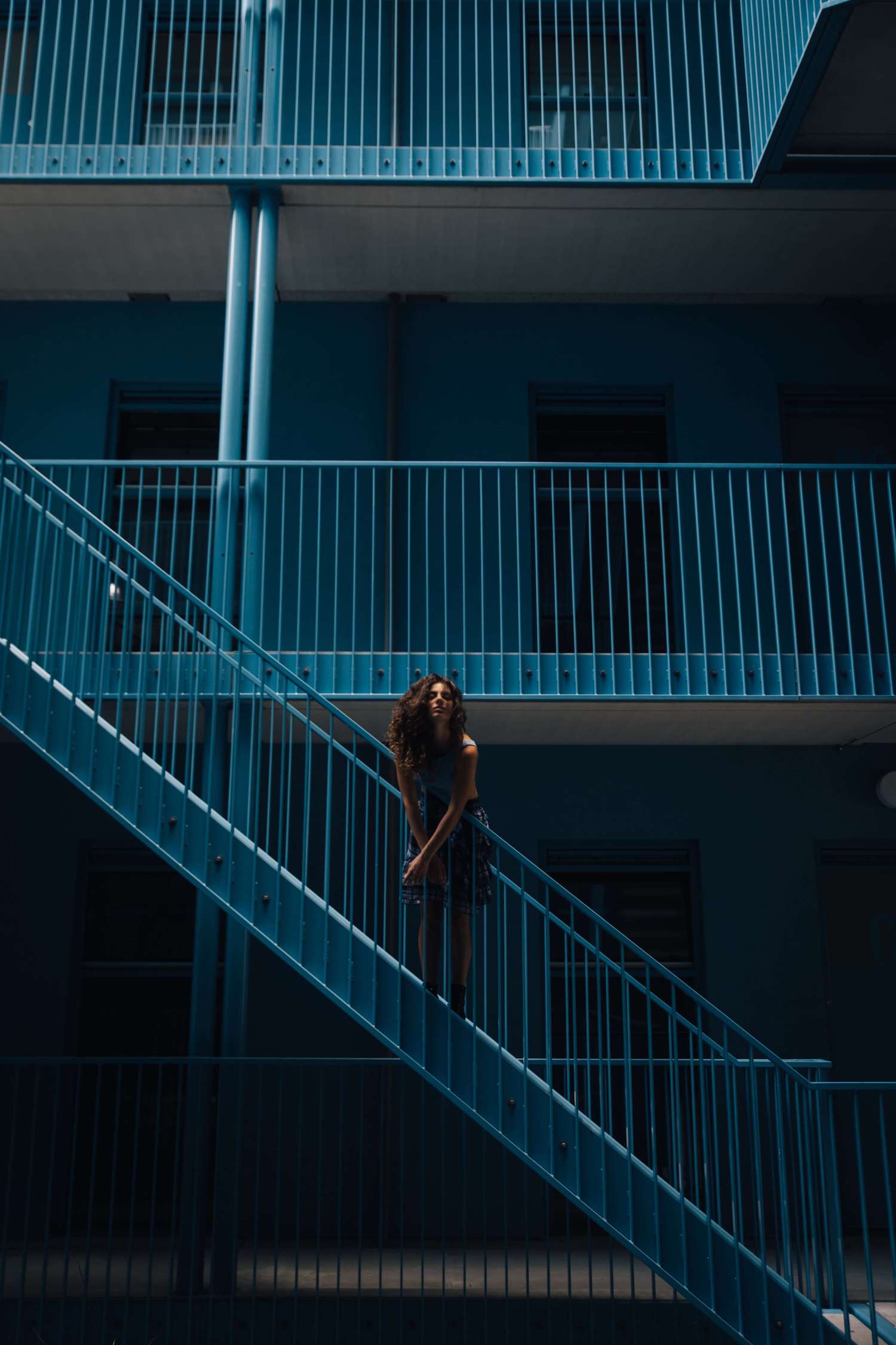 Model in a blue minimalistic building.