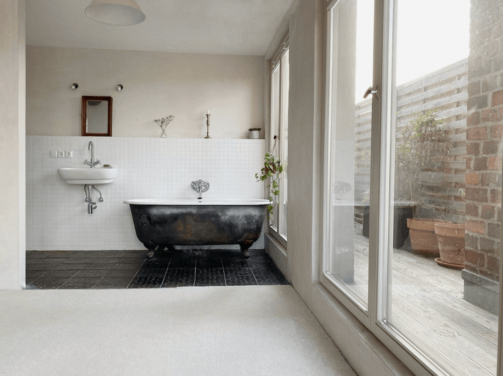 Bathroom of an Artist loft with huge staircase available for rent for your next film production in Berlin, Germany. Minimalist and unique interior design