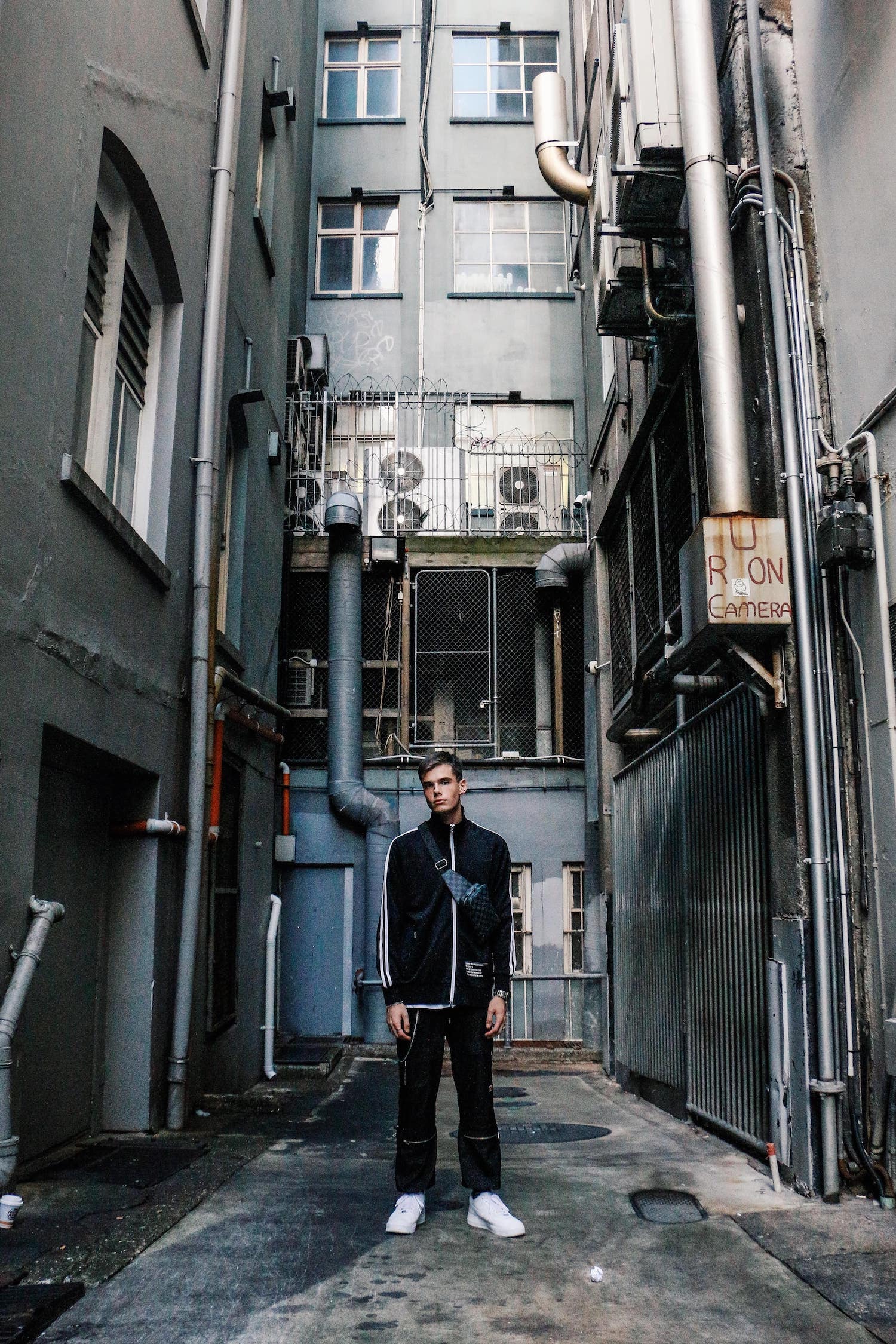 Male model posing in a dead-end street.