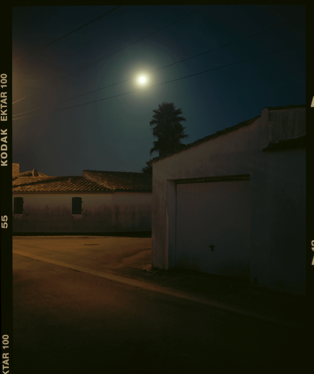 Photograph taken with an analogue camera of a village at night.