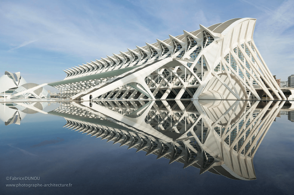 Modernist architectural structure reflected in an artificial lake.