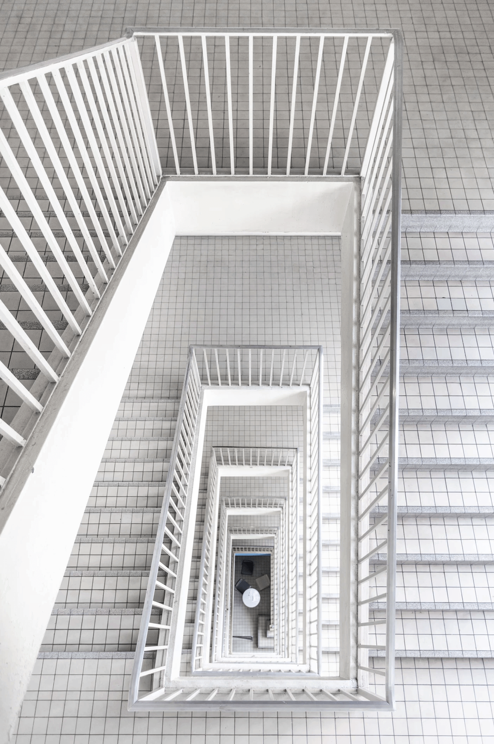 White tiled stairs inside a building.