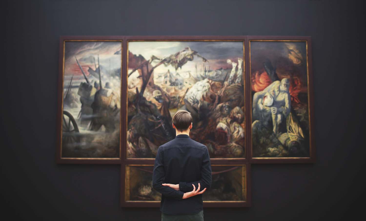 A man contemplating a picture in a museum.
