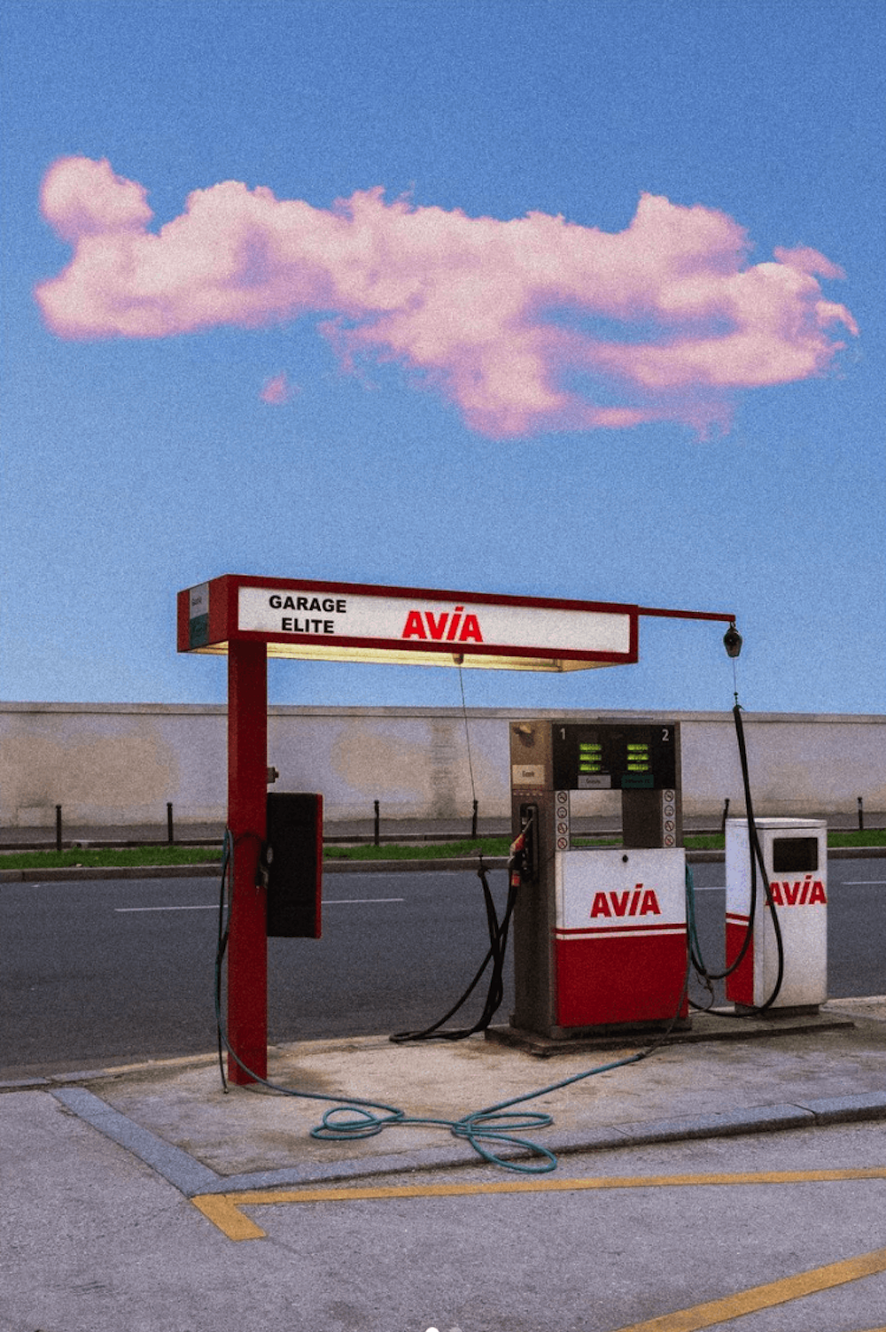 A petrol station in the middle of an empty road.
