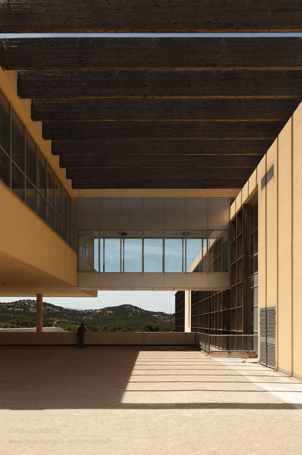Geometrically shaped building with a log roof.
