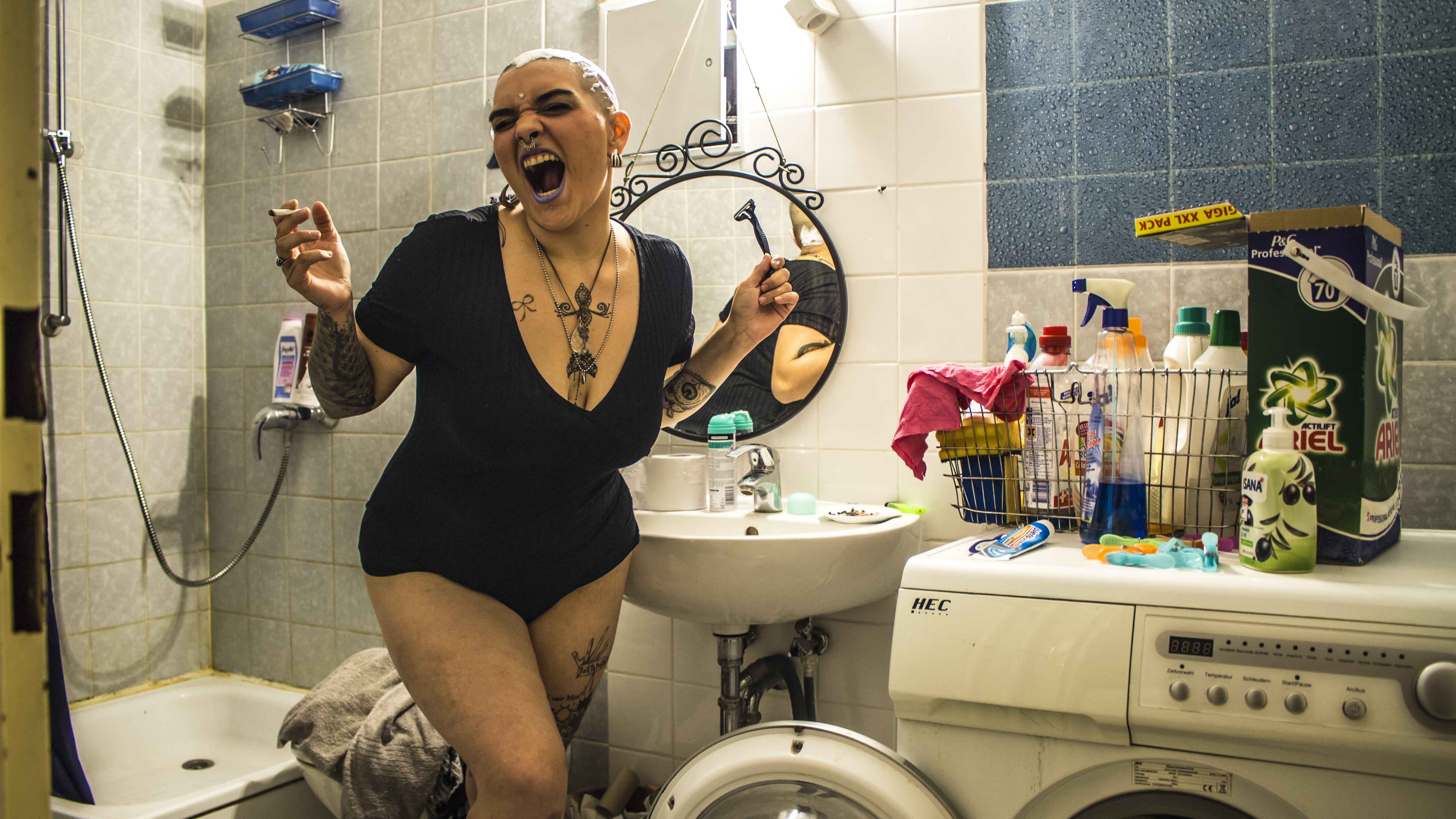 Woman smoking in a bathroom, photograph of Paco Pennino who won the Beazy Architecture contest