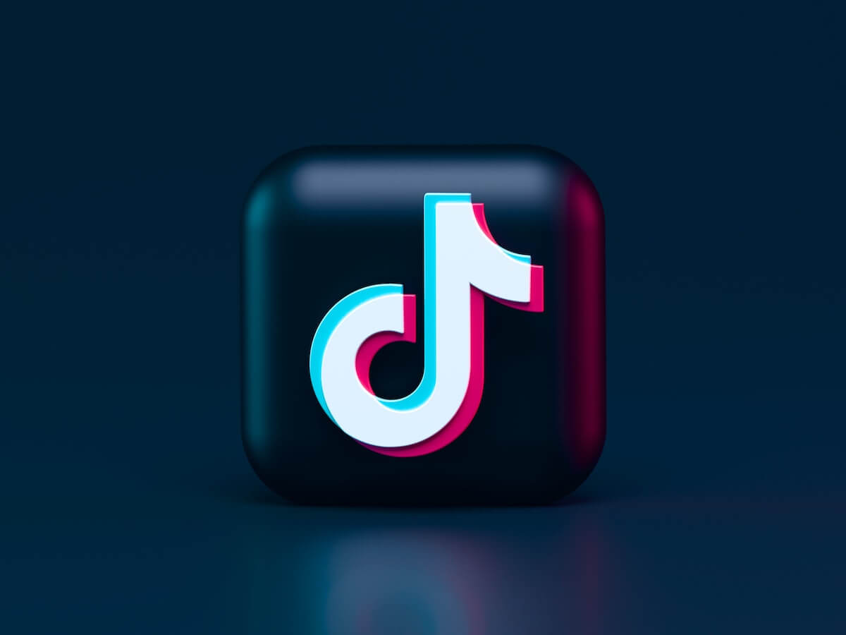 TikTok logo on dark background.