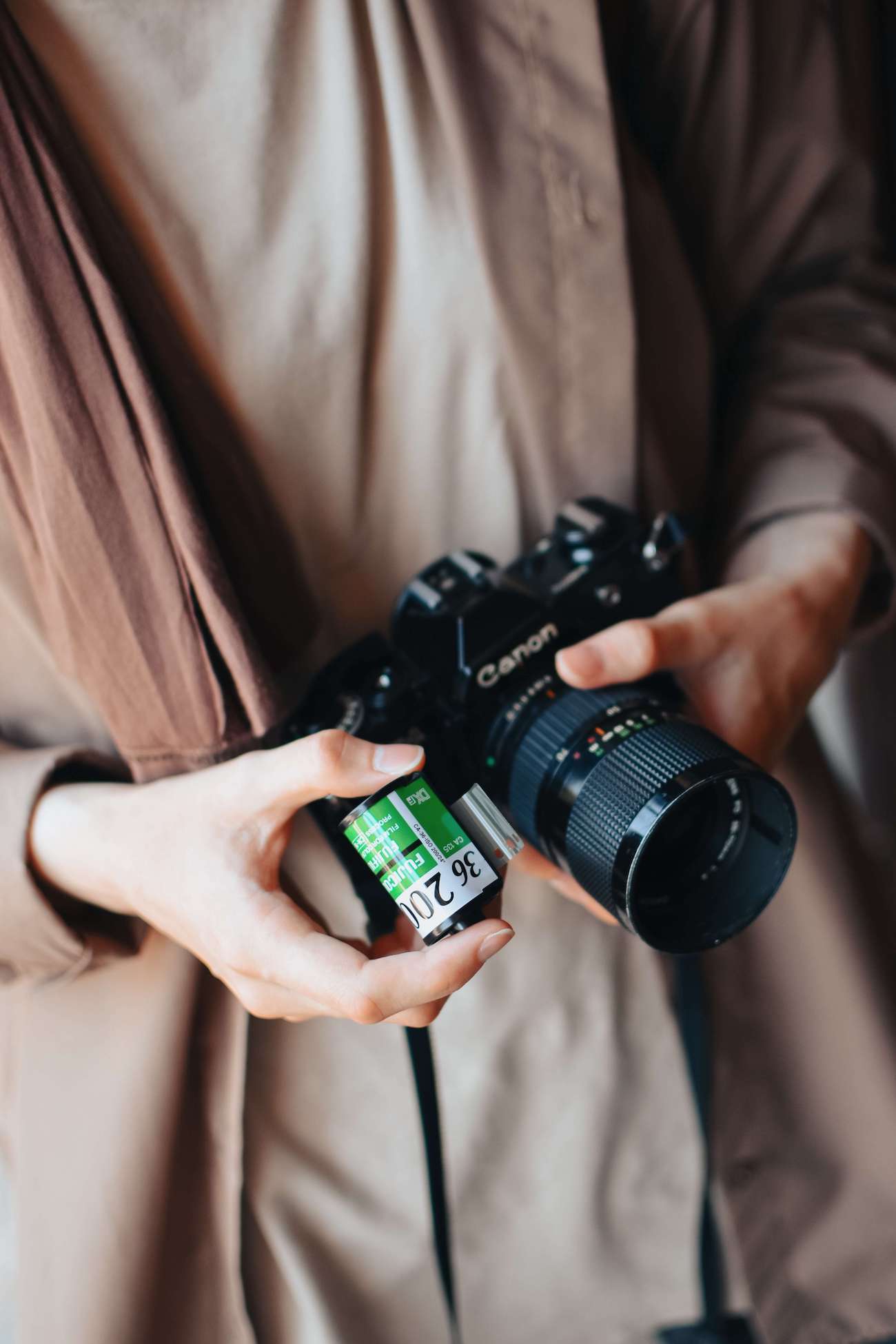 The importance of brand photography, photographer holding a canon camera.